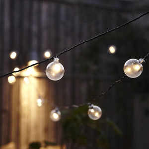 Elegant string lighting garden lighting with bare light bulbs on black wire